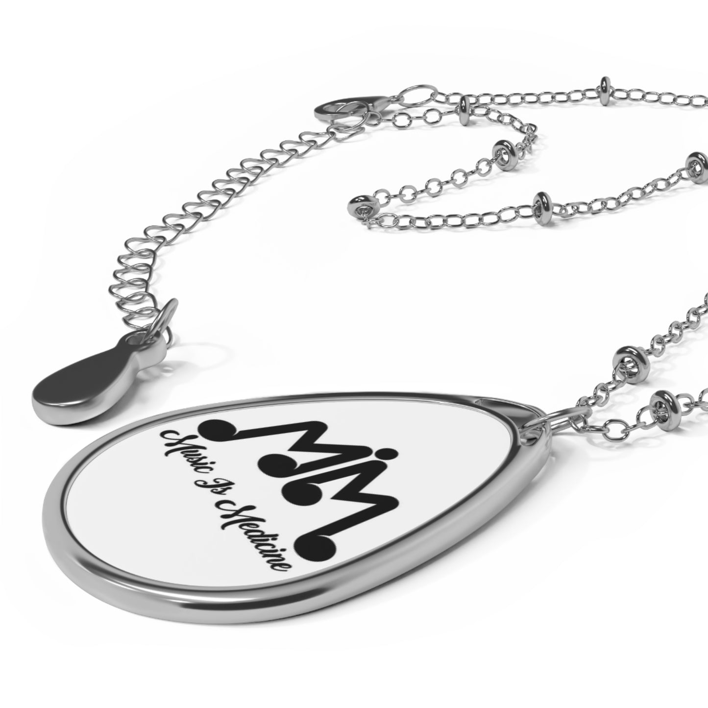 Oval Necklace with the Music Is Medicine stamped logo.